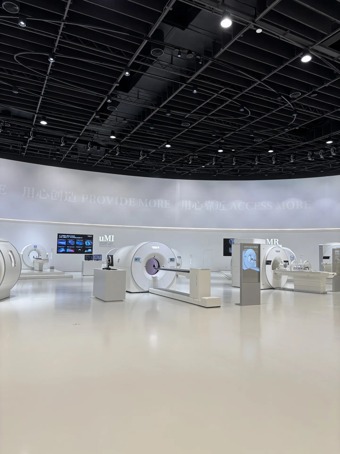 The United Imaging showroom with several white MRI and CT scanners