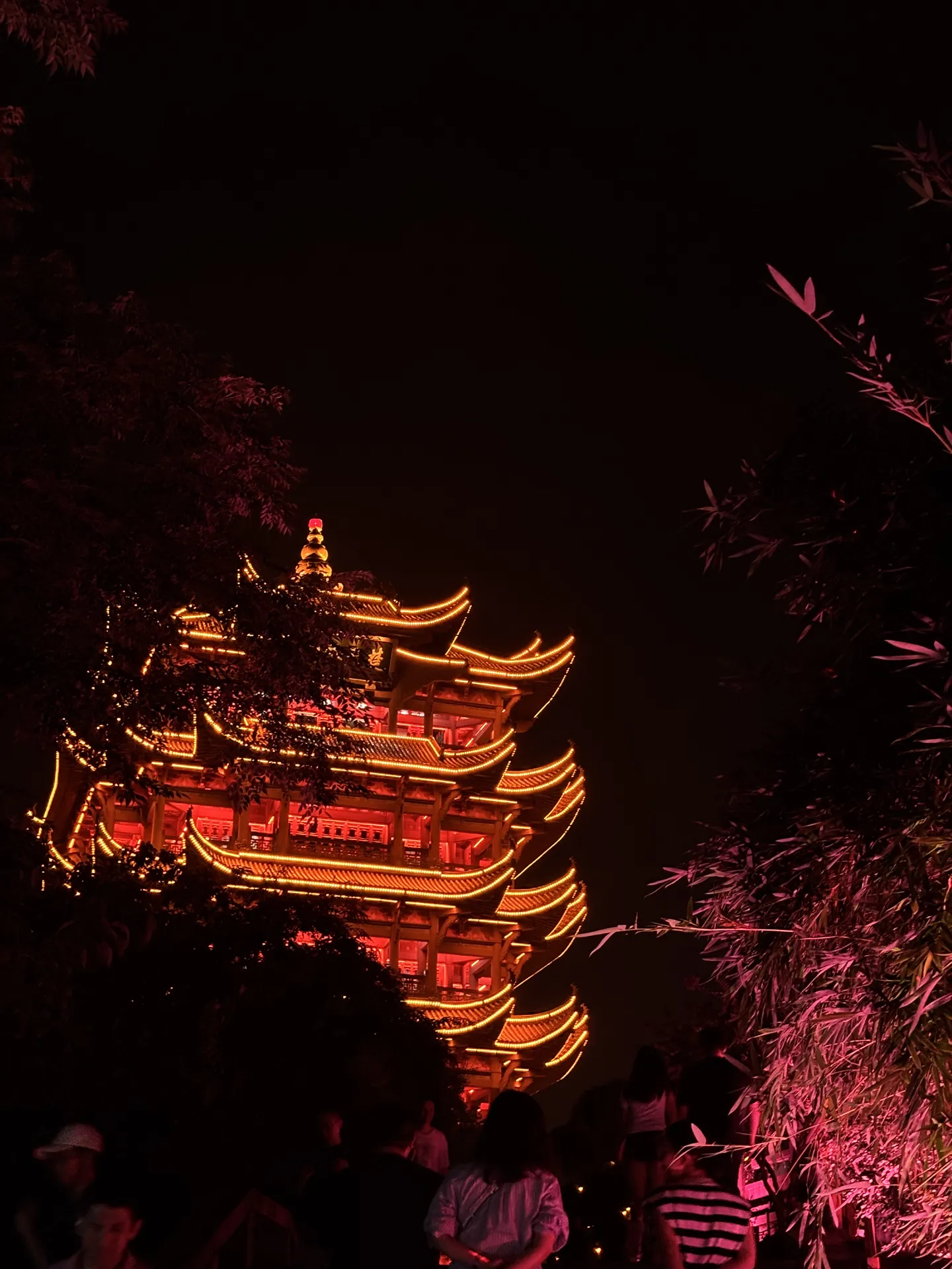 The Yellow Crane Tower lit up in orange at night
