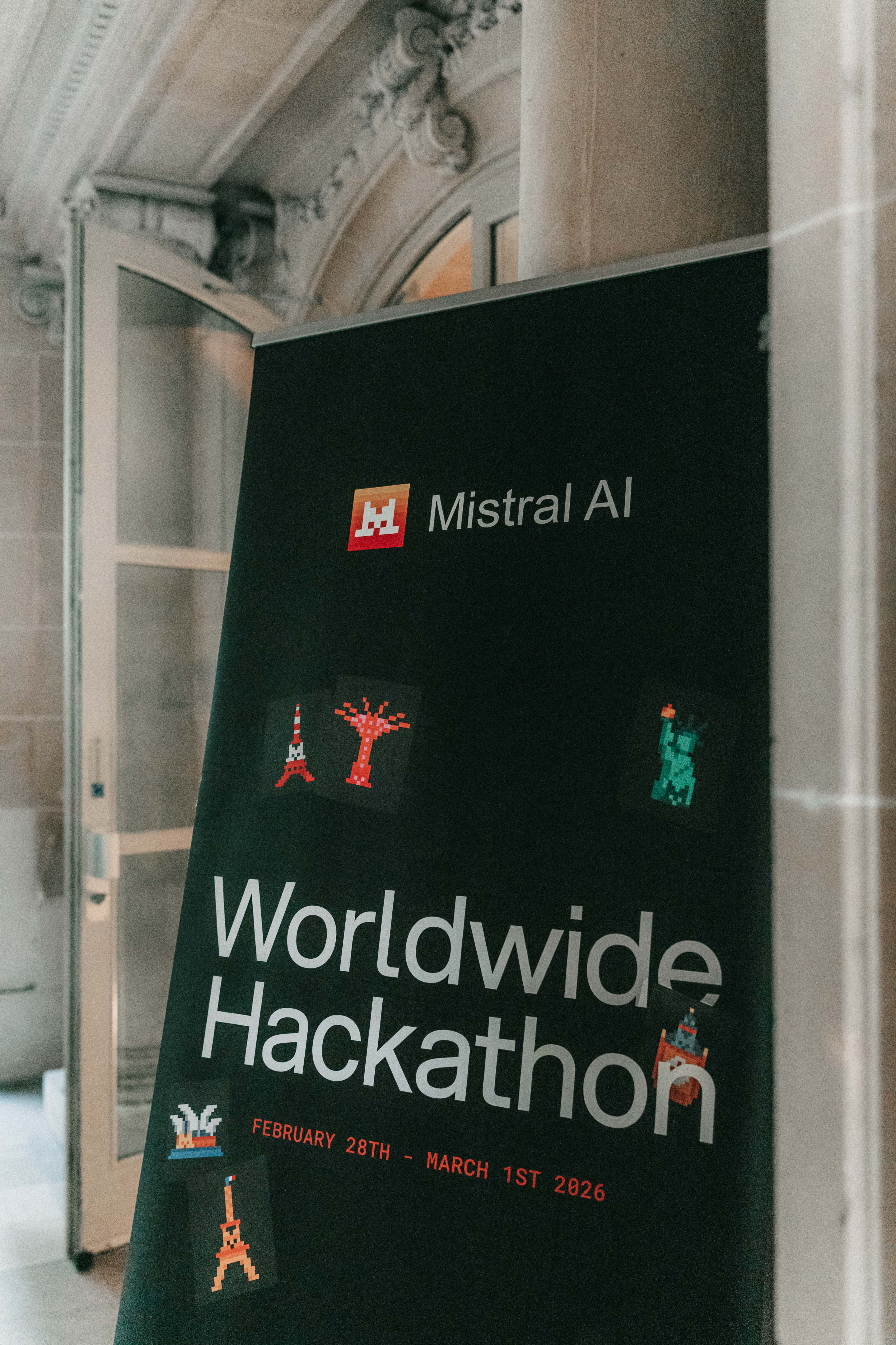 The Mistral AI Worldwide Hackathon banner at the Paris venue, showing February 28th to March 1st 2026